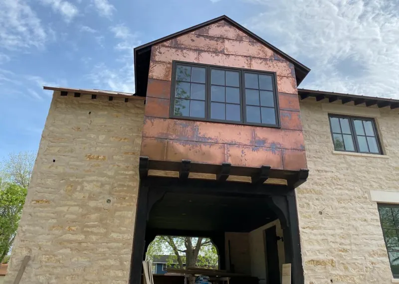 Copper metal panel facade on a stone building for Metal Roof Coating in Victor